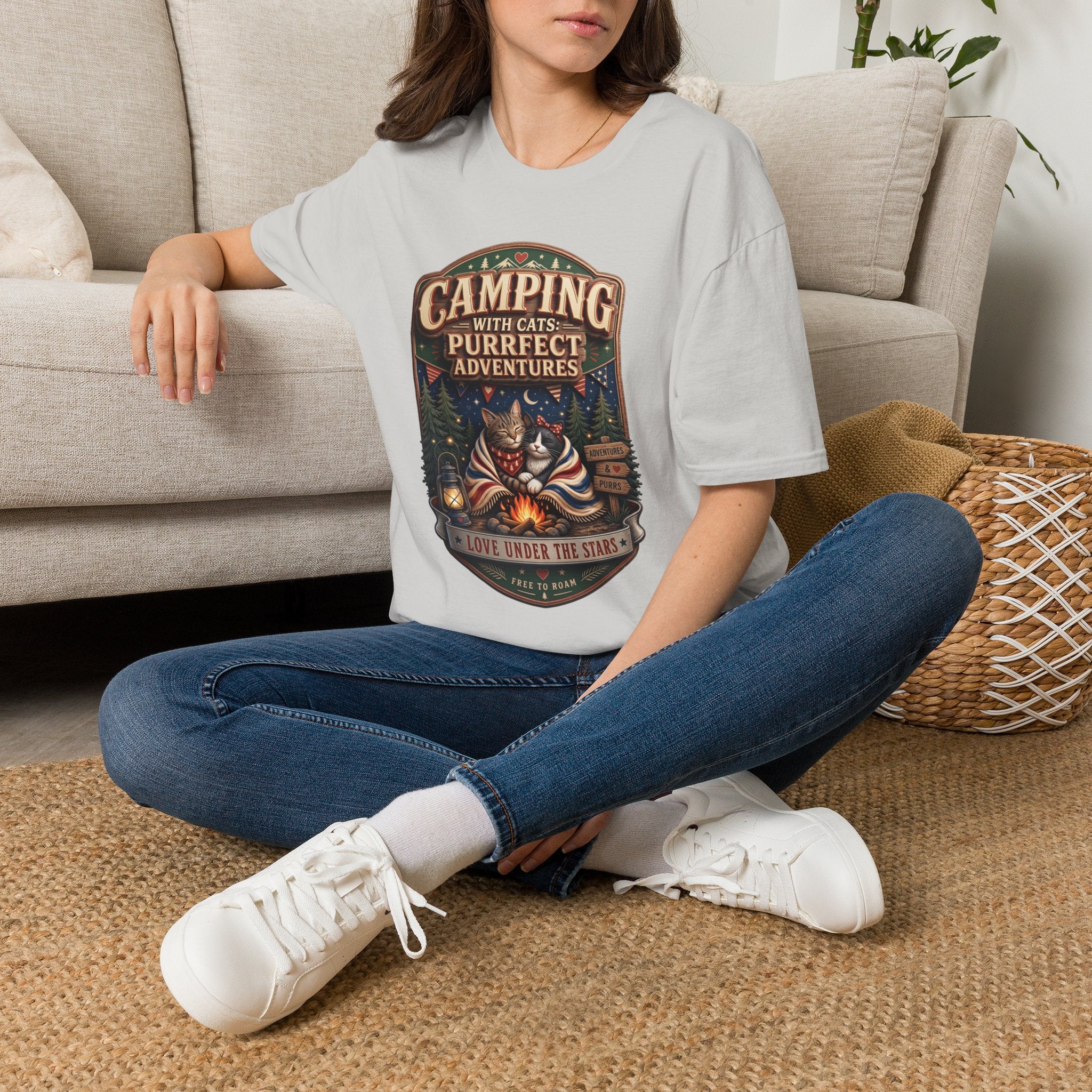 Camping With Cats Purrfect Adventures t-shirt in Ice Grey, worn by a woman seated on a rug