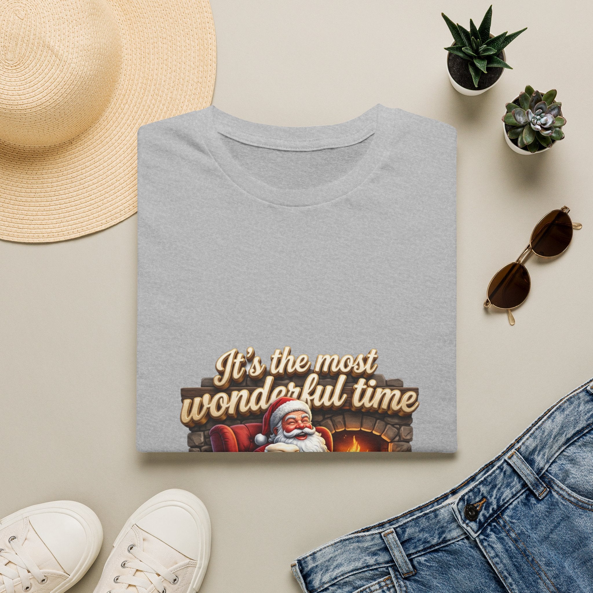 Most Wonderful Time for a Beer Santa print on a Sport Grey t-shirt, folded beside a straw hat and jeans