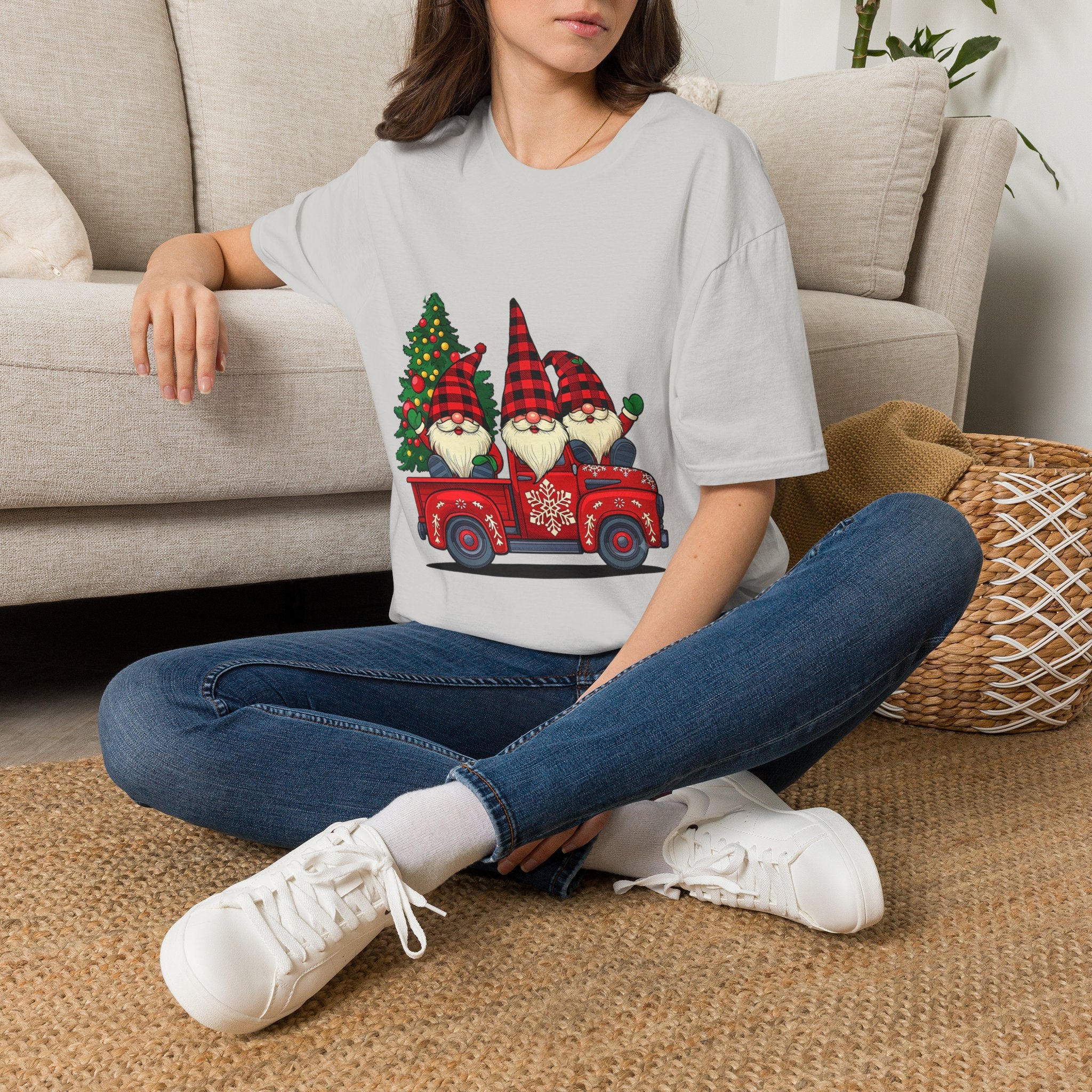 Buffalo Plaid Gnomes Red Truck t-shirt in Ice Grey, worn by a woman seated on a rug