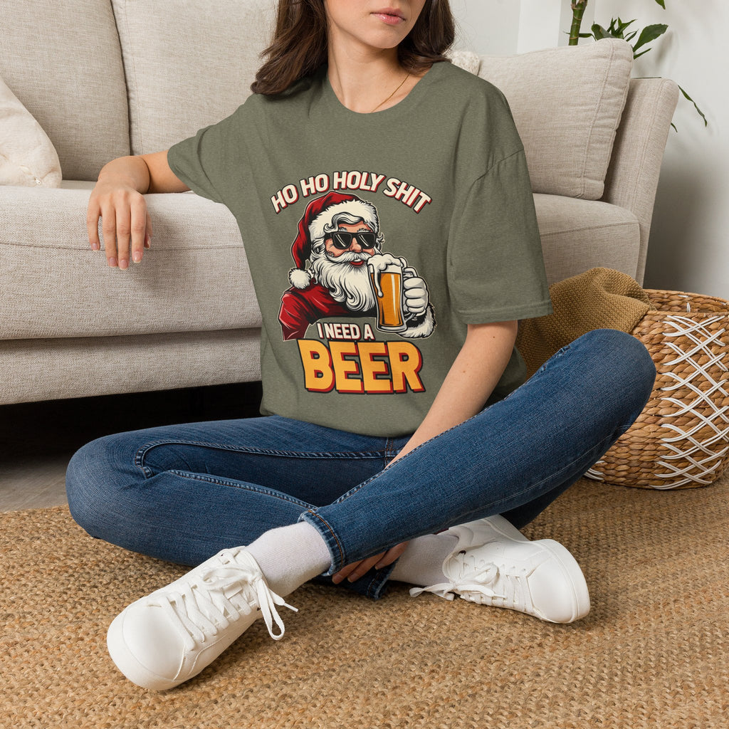 Ho Ho Holy Sh*t I Need a Beer t-shirt in Heather Military Green, worn by a woman seated on a rug