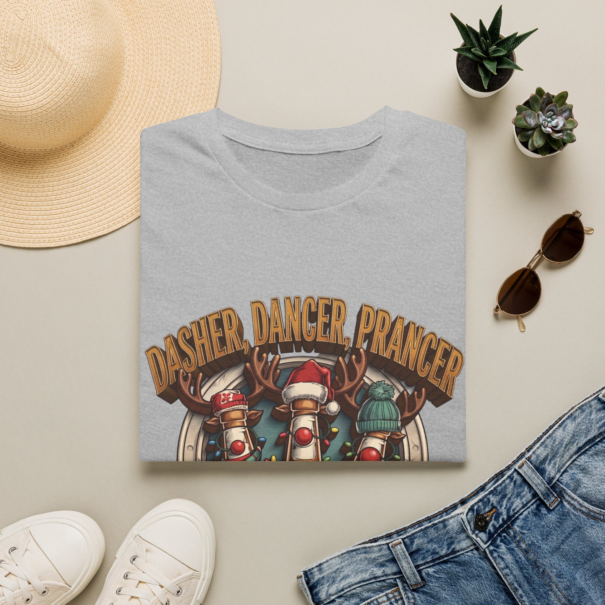 Dasher Dancer Prancer Reinbeer Christmas Beer print on a Sport Grey t-shirt, folded beside a straw hat and jeans