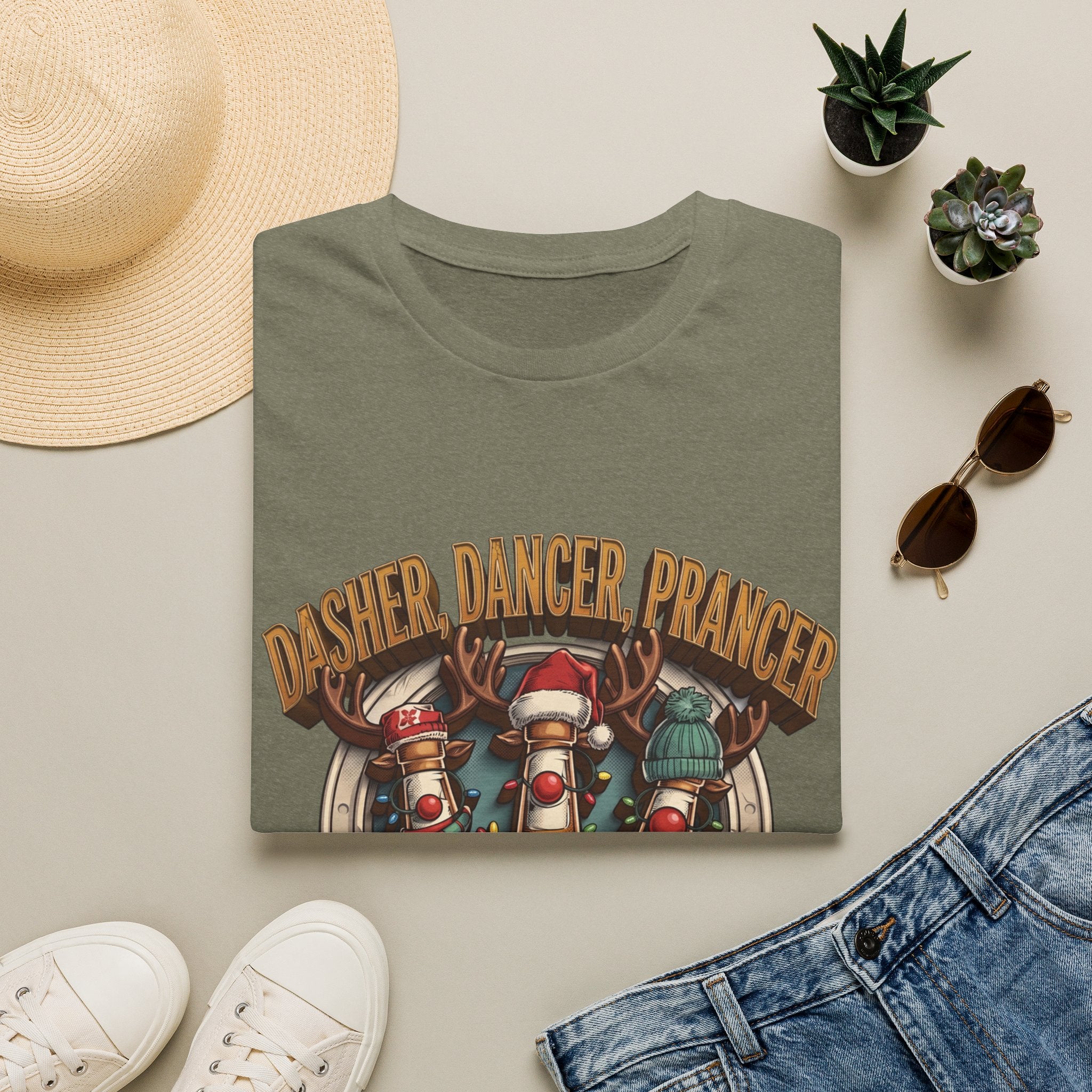 Dasher Dancer Prancer Reinbeer Christmas Beer print on a Heather Military Green t-shirt, folded beside a straw hat and jeans
