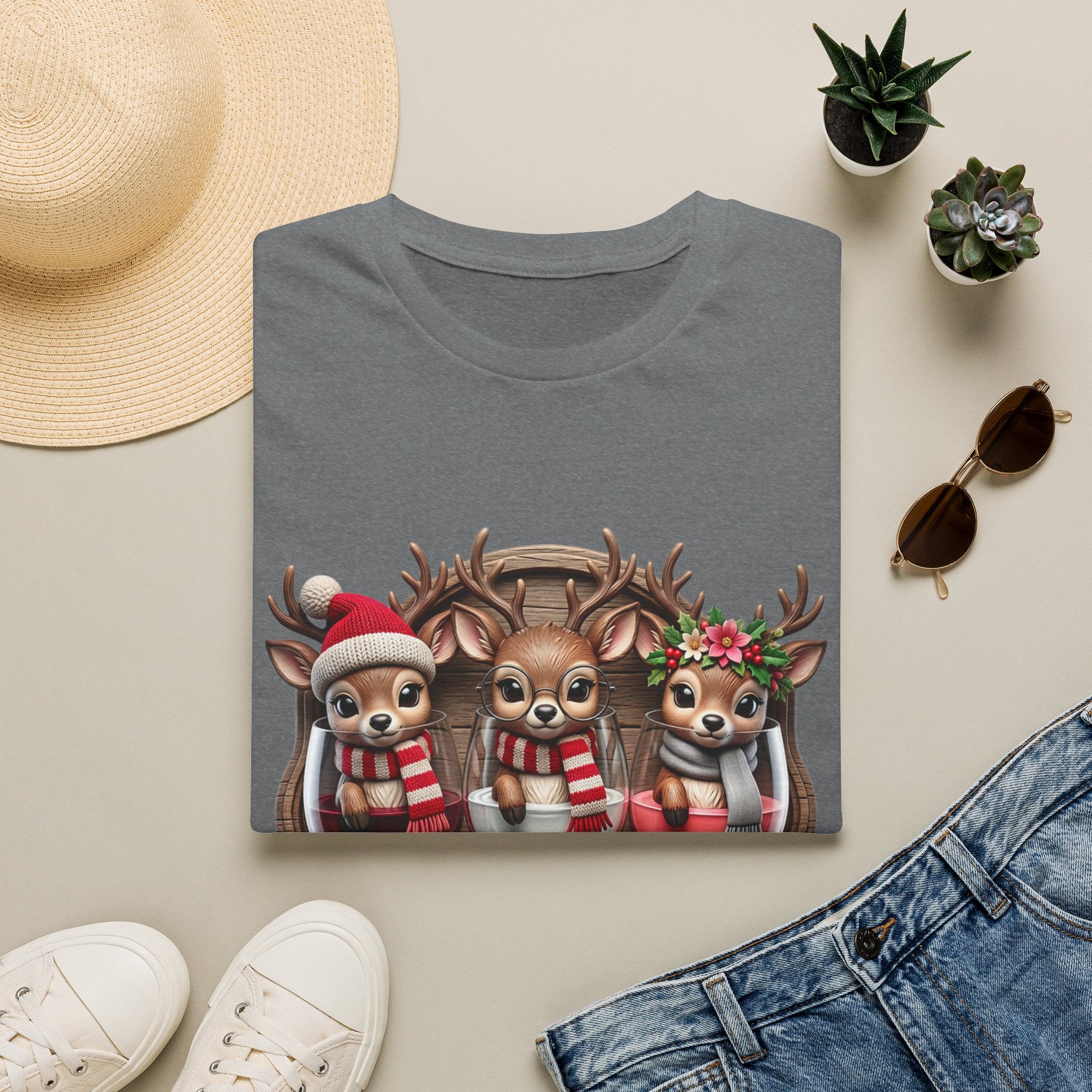 Drink Drank Drunk Reindeer Wine Trio print on a Graphite Heather t-shirt, folded beside a straw hat and jeans