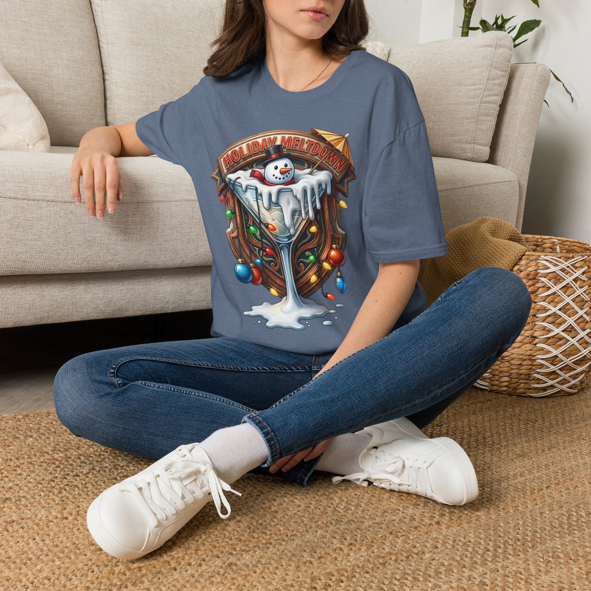 Holiday Meltdown Snowman Martini t-shirt in Heather Indigo, worn by a woman seated on a rug