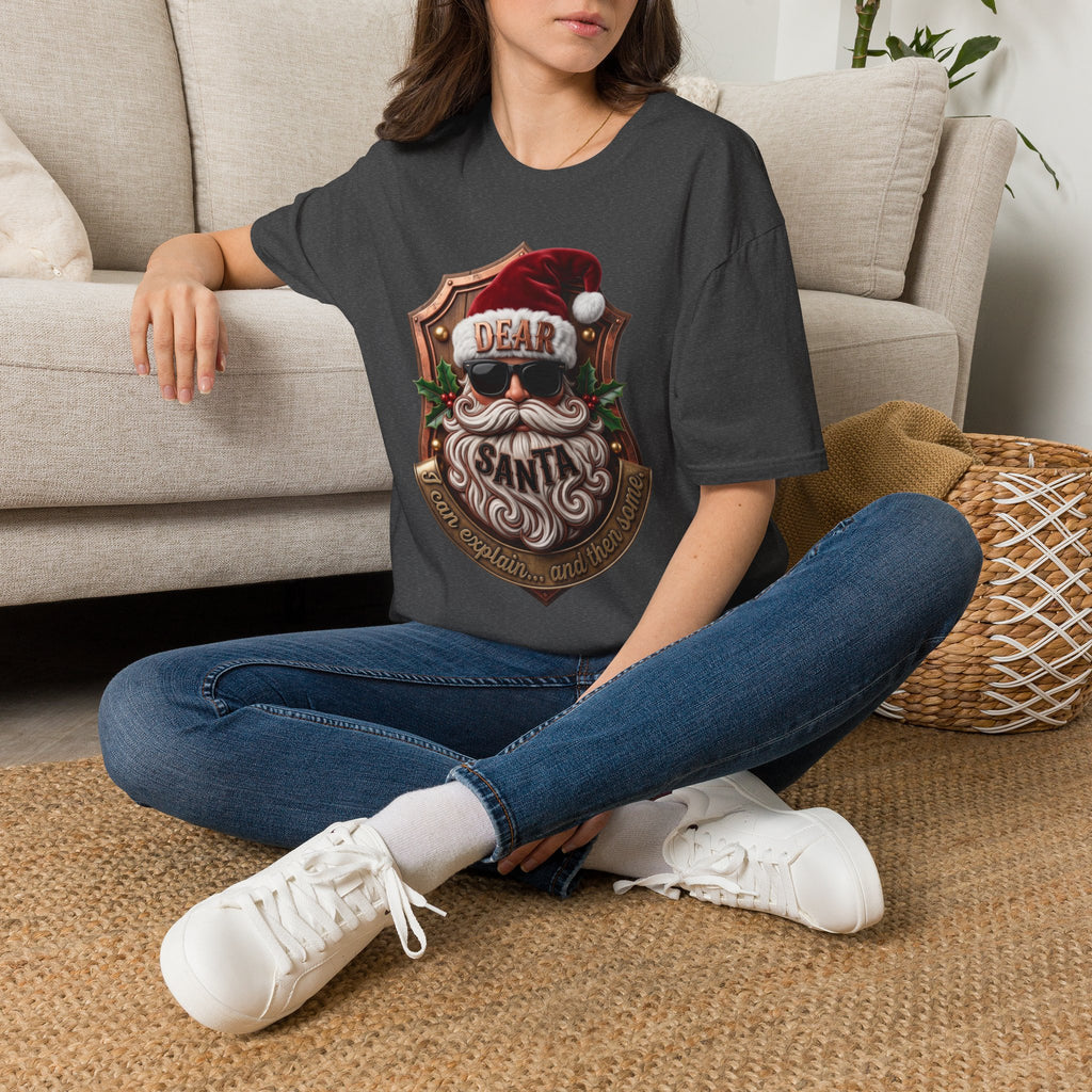 Dear Santa I Can Explain Sunglasses Crest t-shirt in Dark Heather, worn by a woman seated on a rug