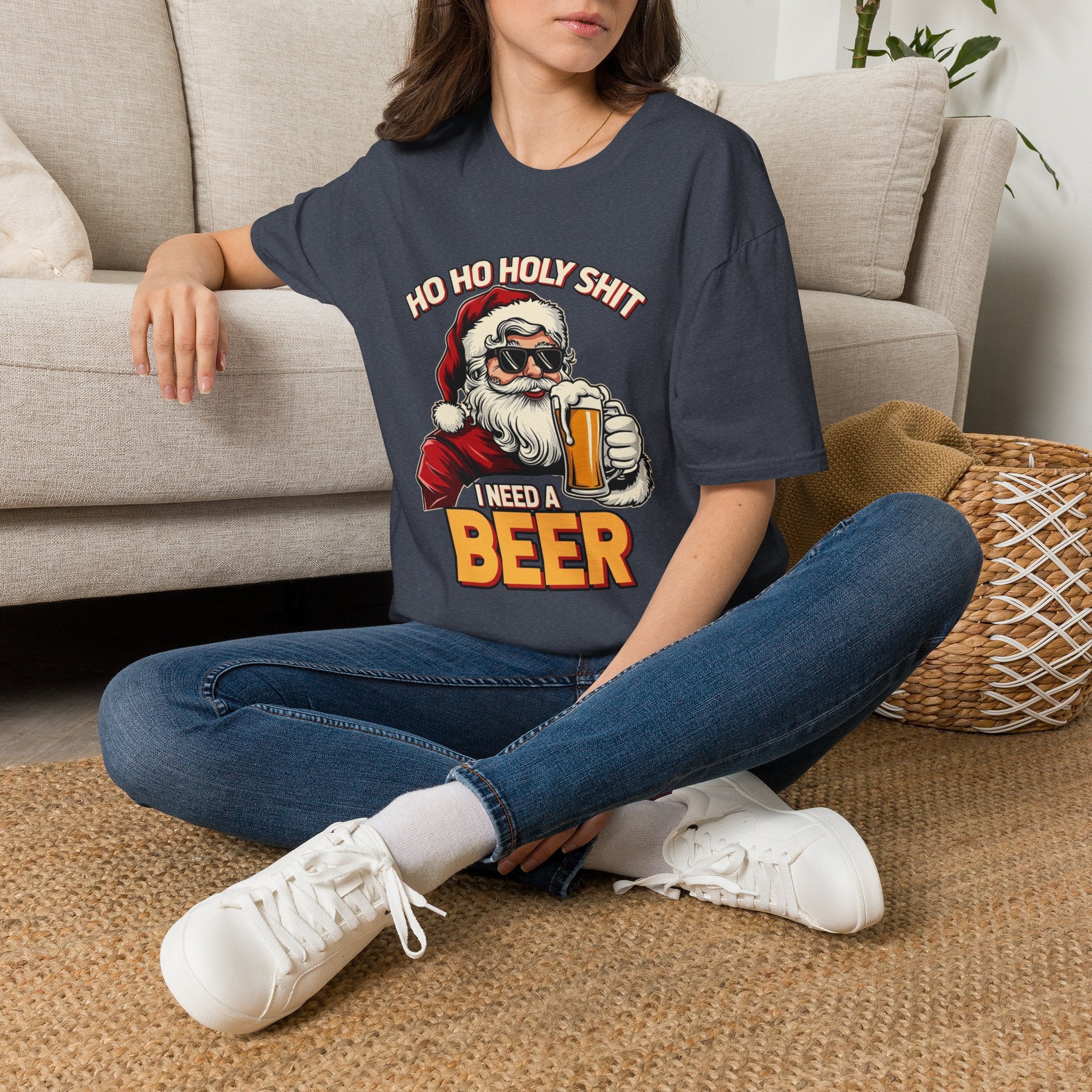 Ho Ho Holy Sh*t I Need a Beer t-shirt in Heather Navy, worn by a woman seated on a rug