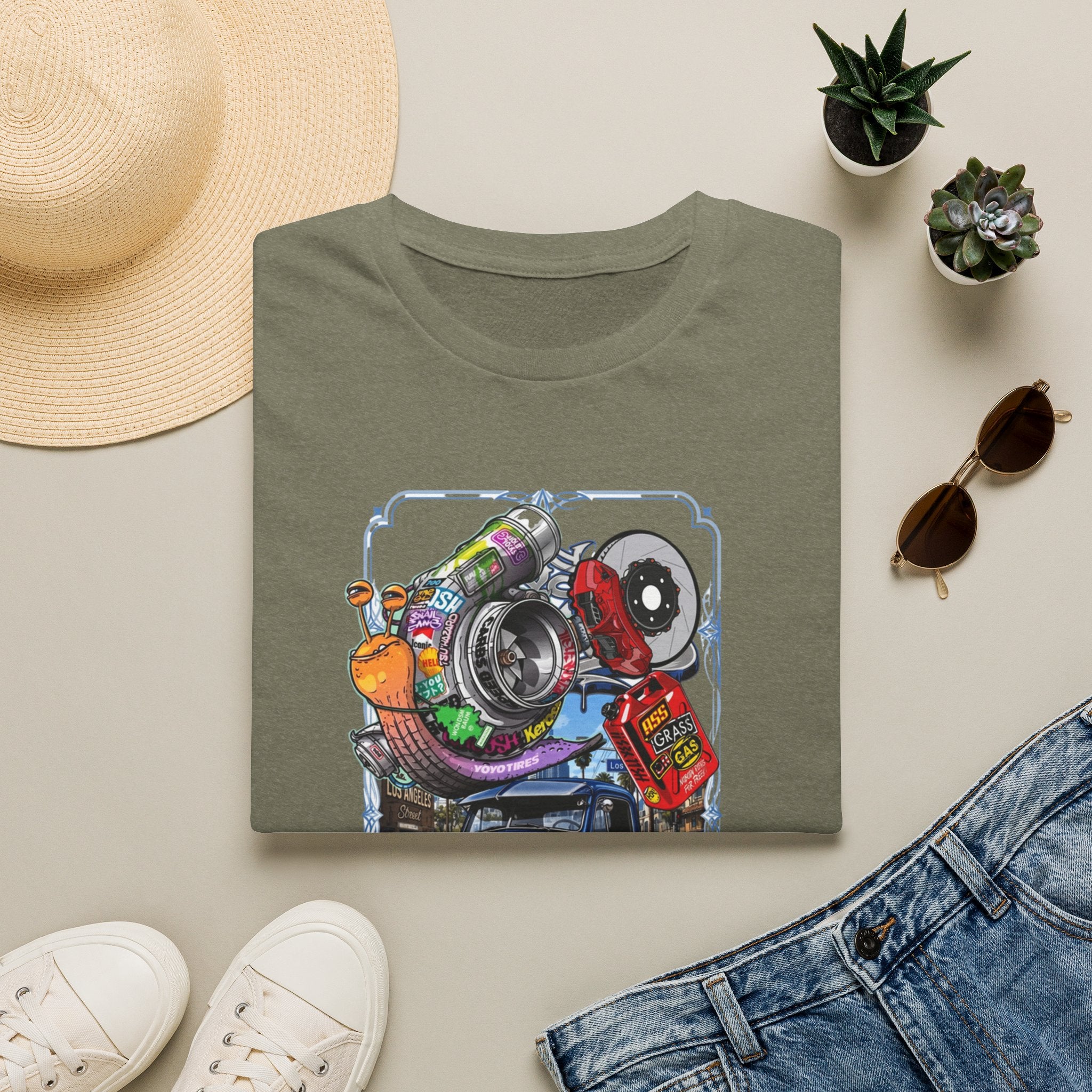 Turbocharged Snail Gearhead Car Parts print on a Heather Military Green t-shirt, folded beside a straw hat and jeans